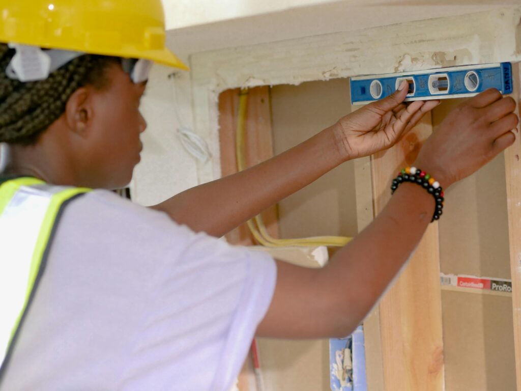 Contractor and clients reviewing house blueprints at a construction site in Chennai